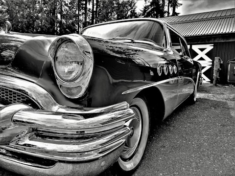 A beautifully restored vintage car parked outdoors.