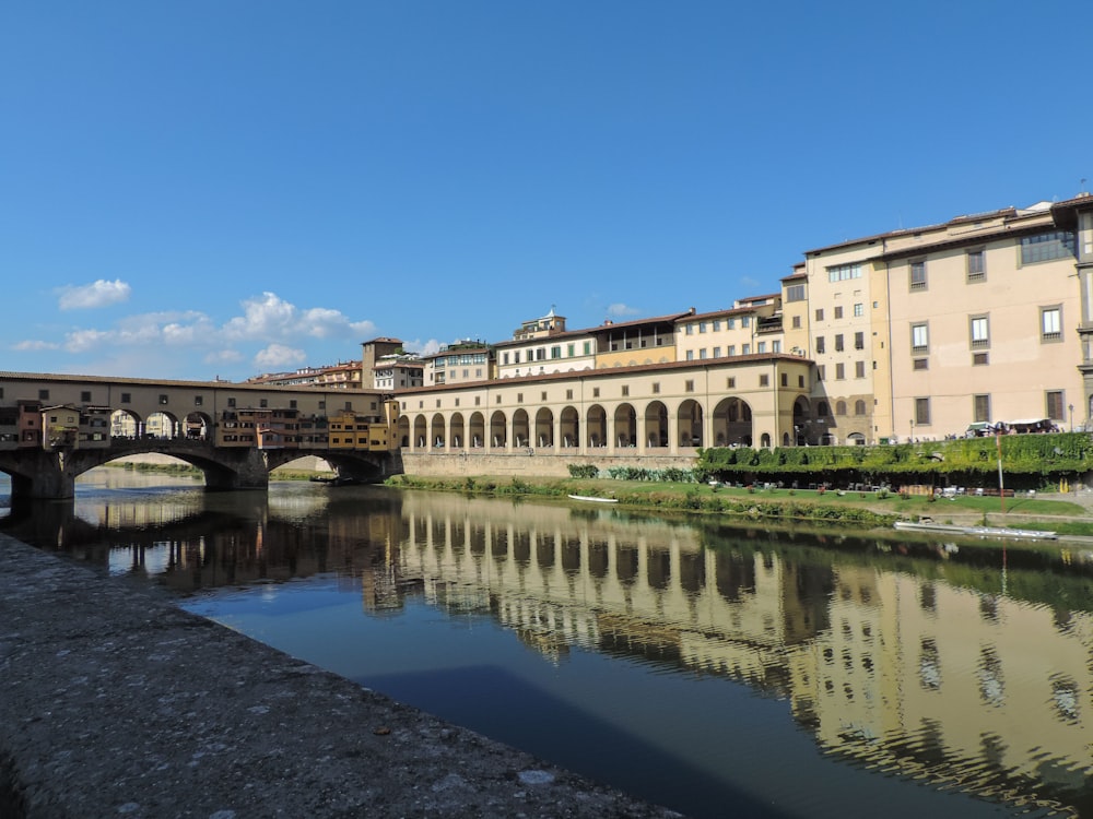 a river with a bridge and buildings along it