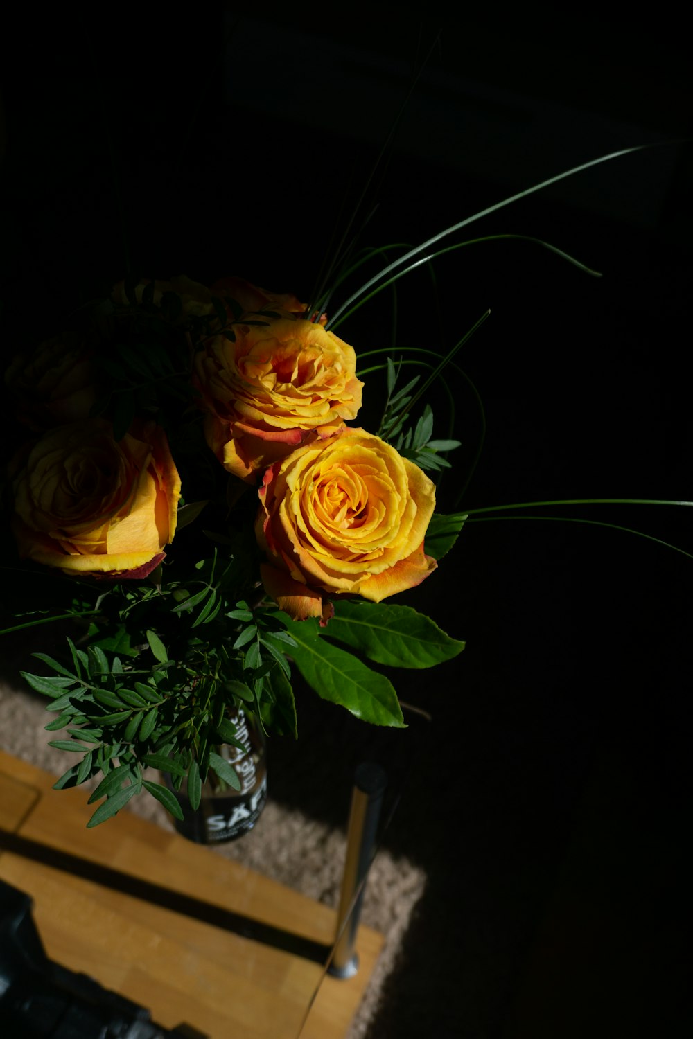 a couple of roses in a vase