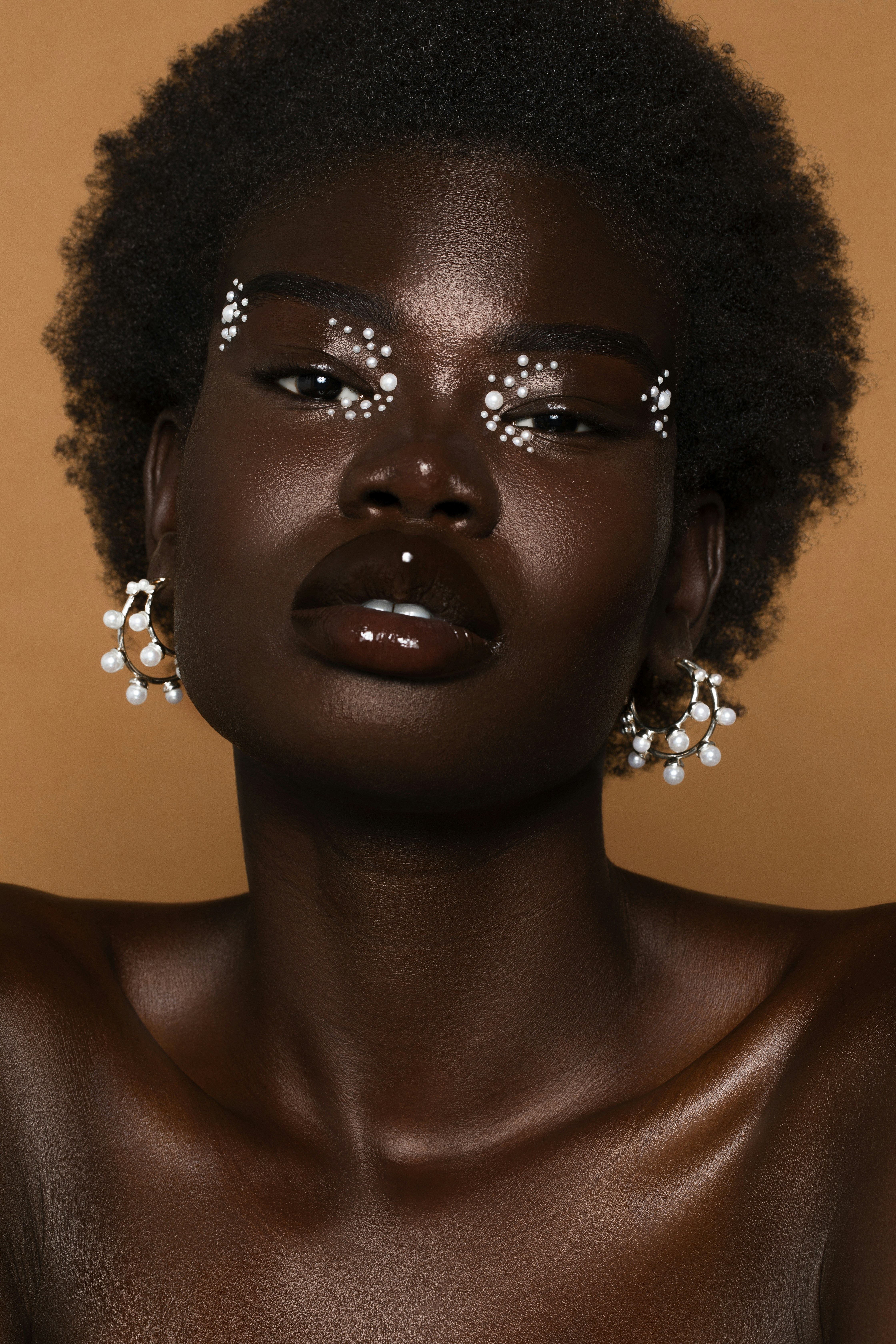 a man with a large nose and earrings