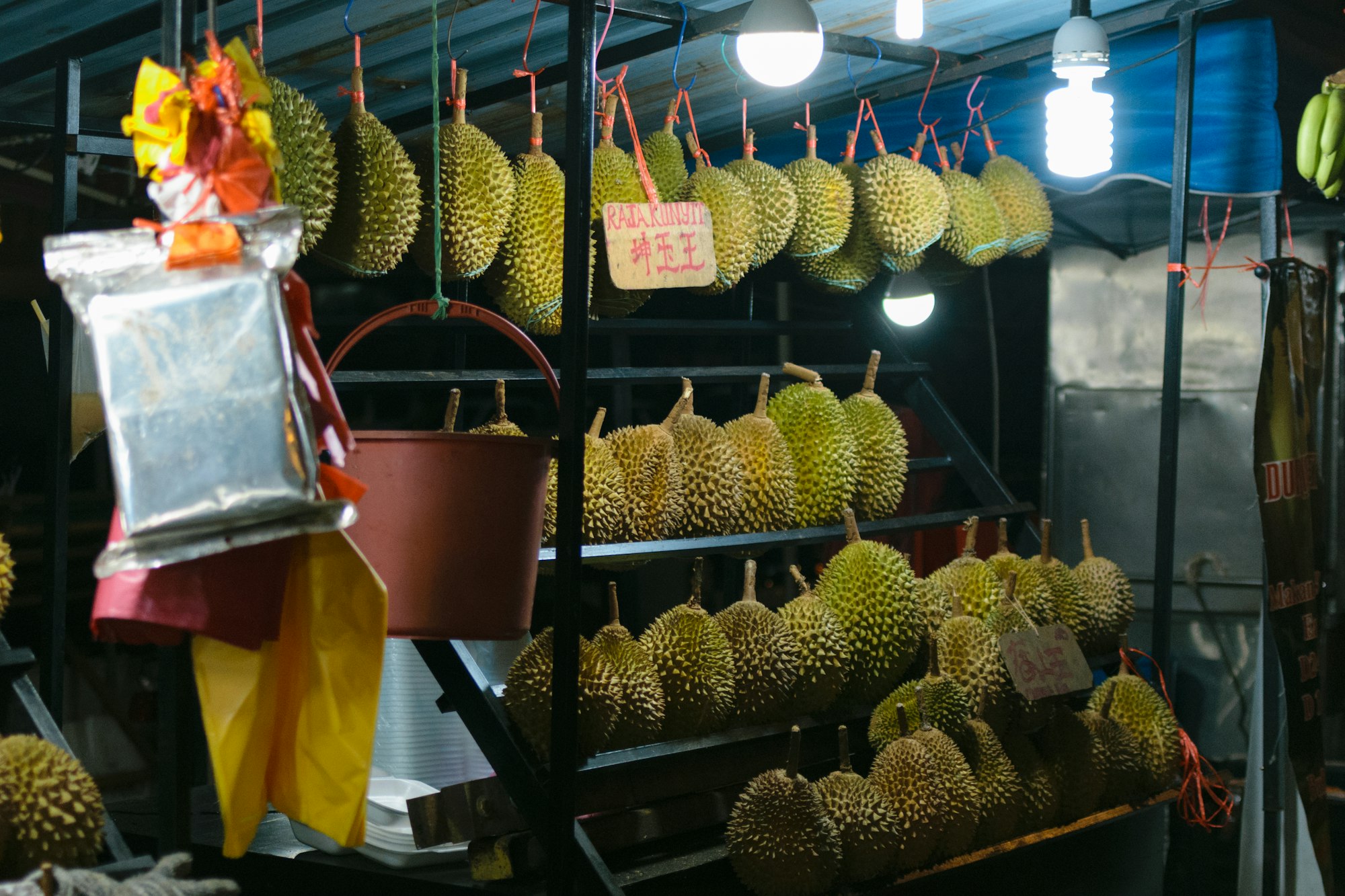 A market stand selling a variety of Durian fruits at night in Kuala Lumpur, Malaysia