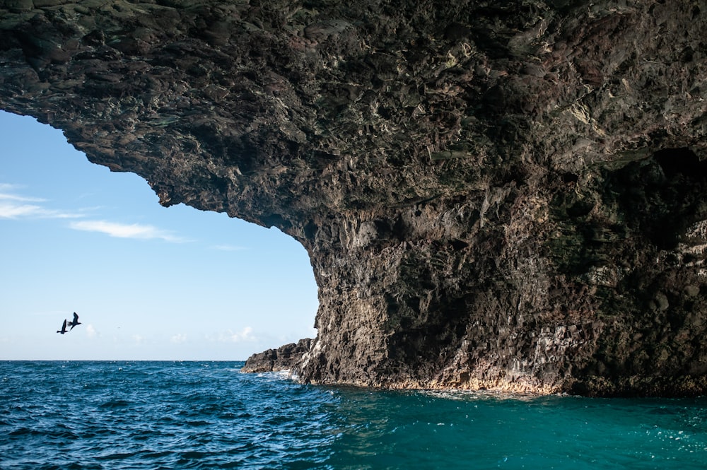 a cliff with a body of water below