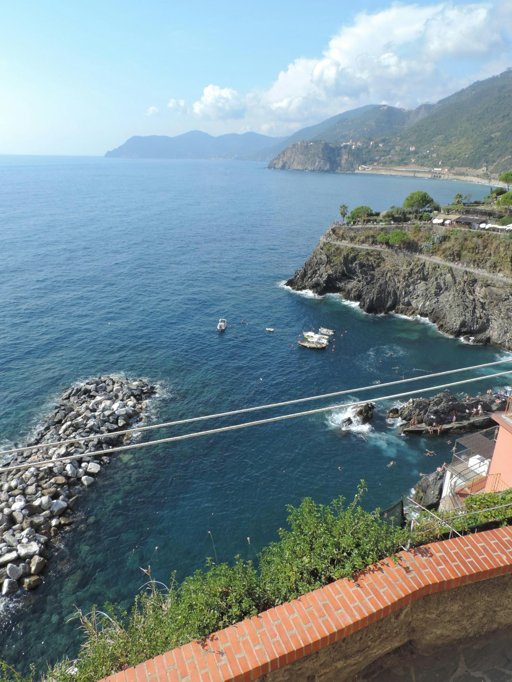 a body of water with a rocky shore and a boat in it