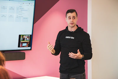a person standing in front of a screen with the hands out