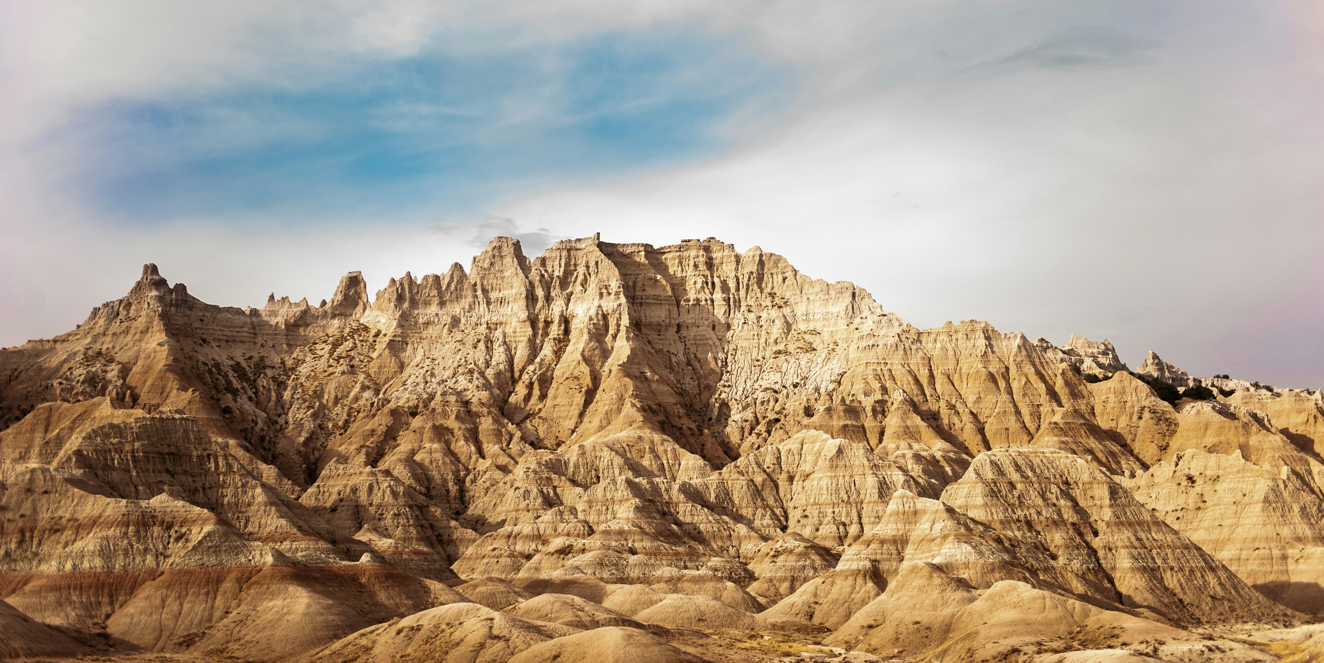 a rocky mountain with a cloudy sky