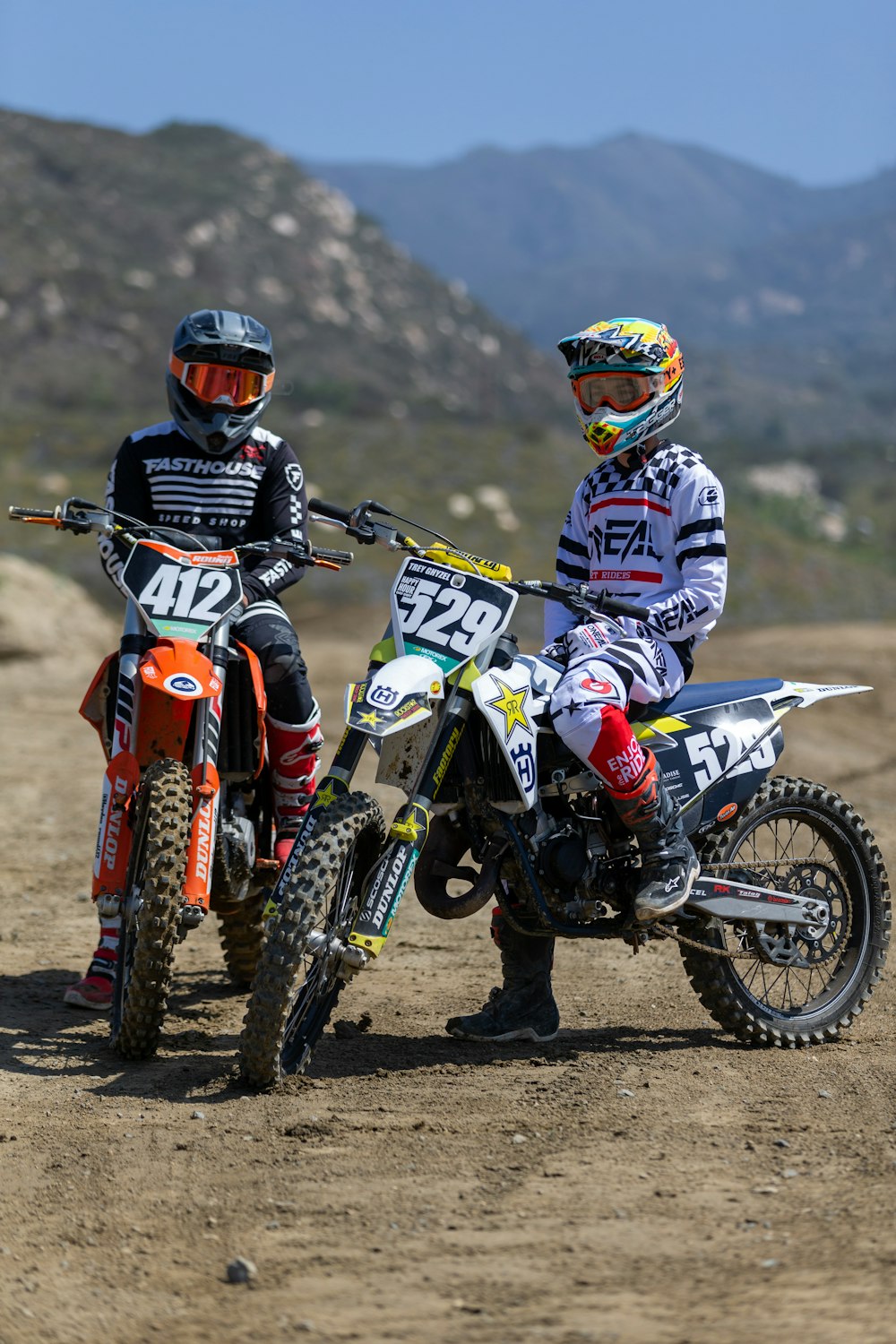 two people on dirt bikes