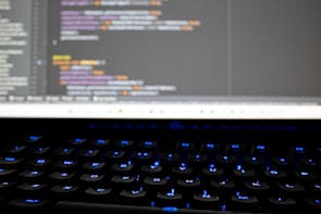 A close-up of a student programming a robot.
