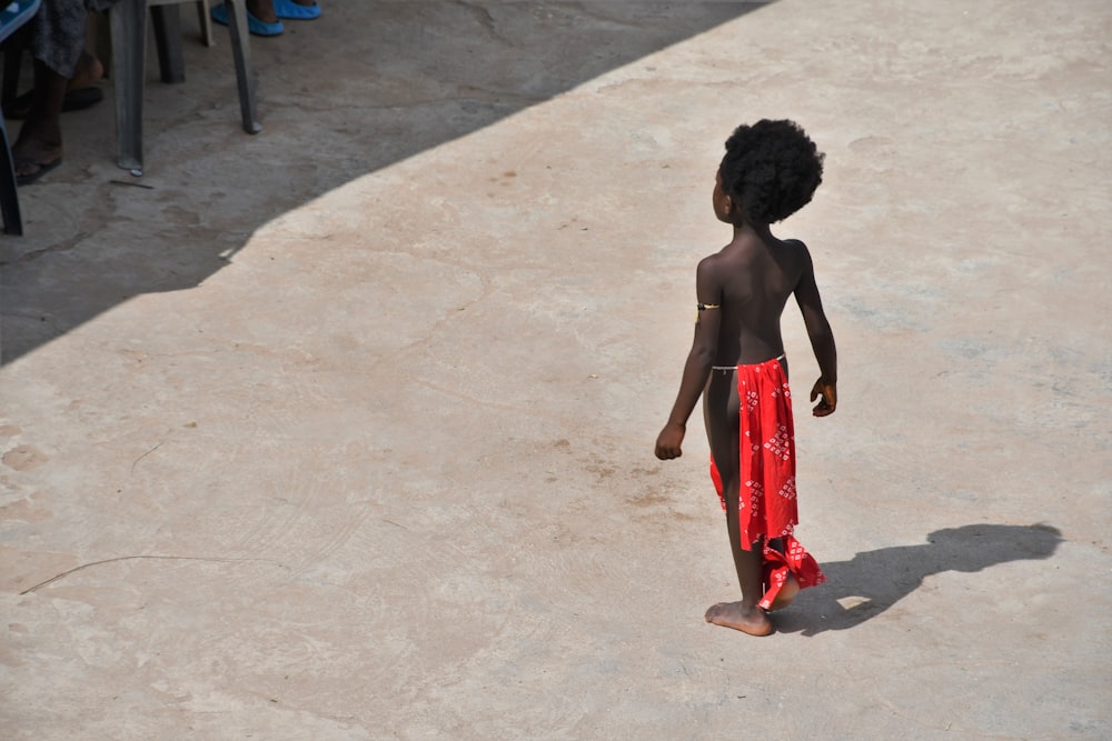 a boy walking on a beach