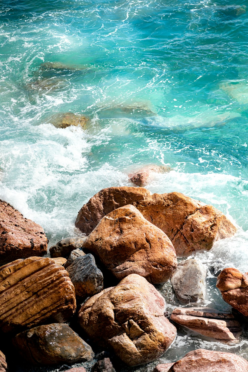 a group of rocks by the water