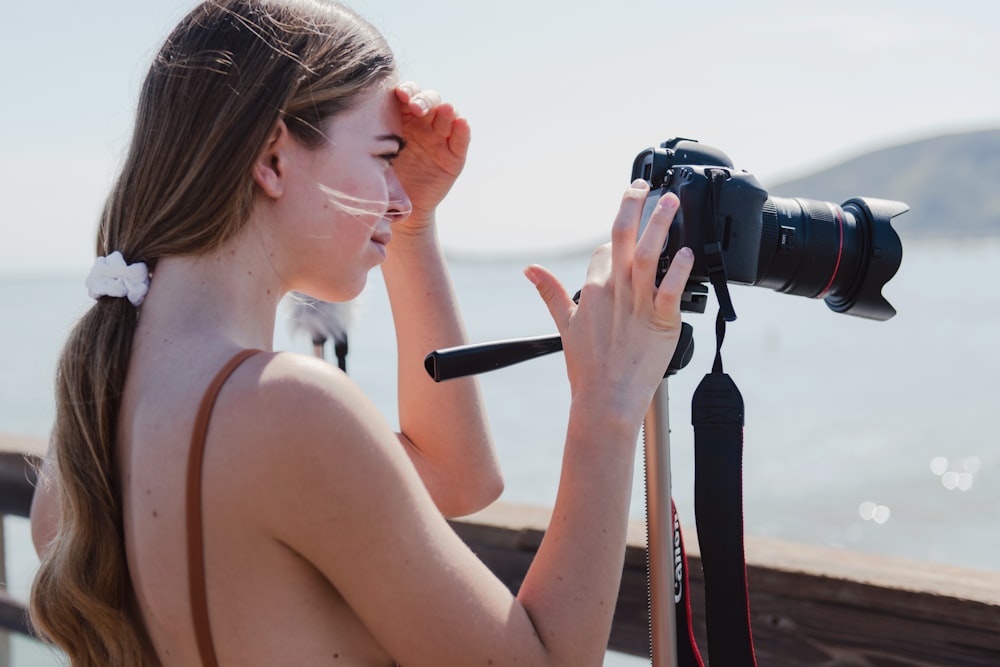 a woman looking through a camera