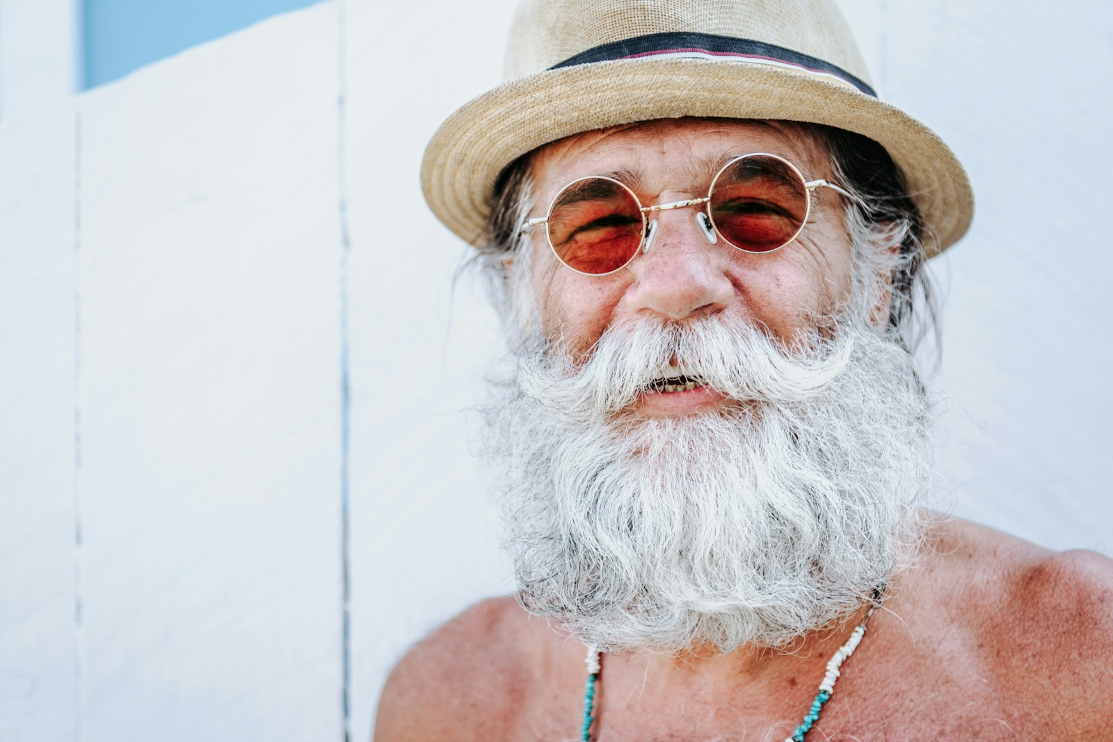Smiling bearded man wearing a hat after a workout, bathed in golden light