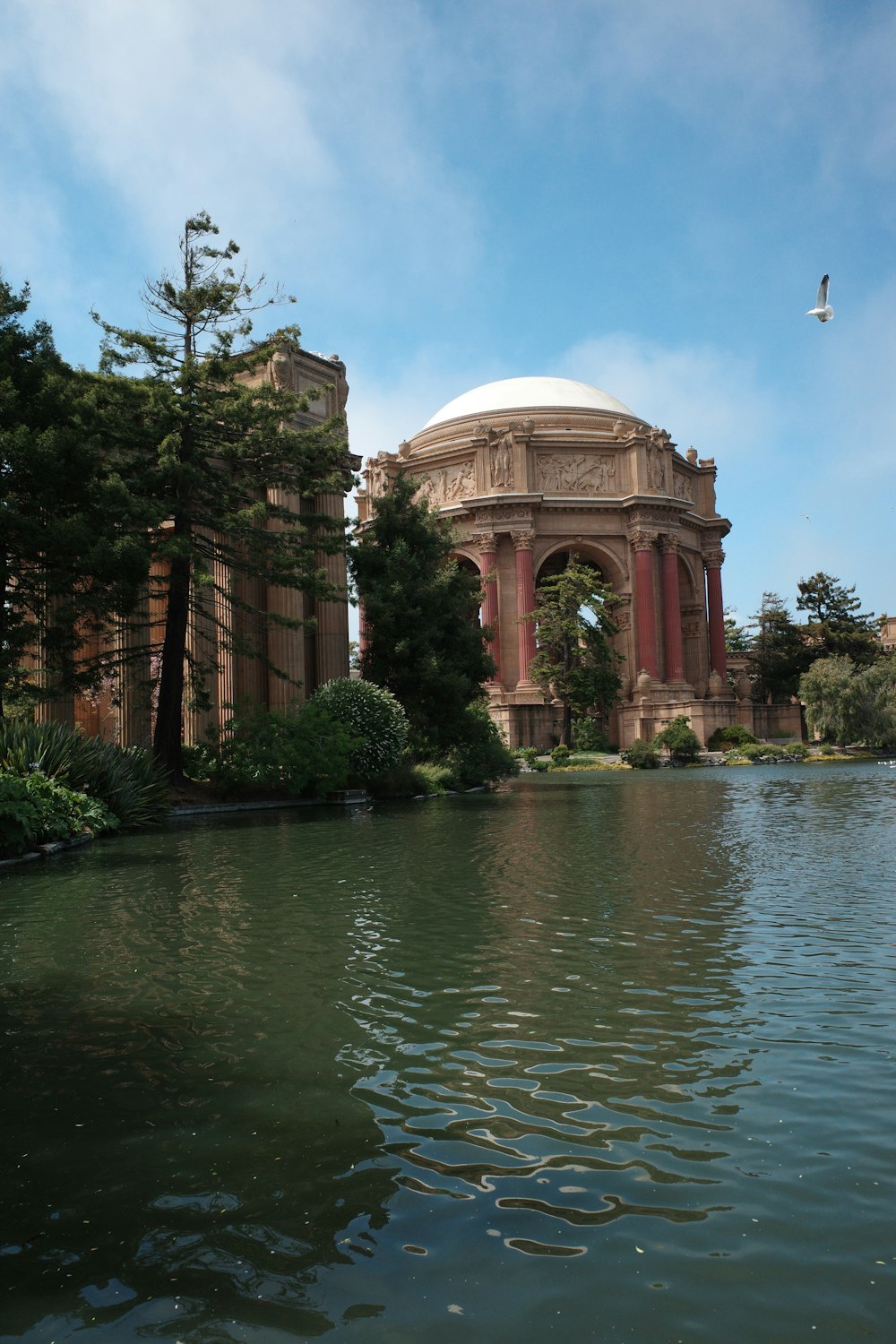 Palace of Fine Arts with pillars and a body of water in front of it