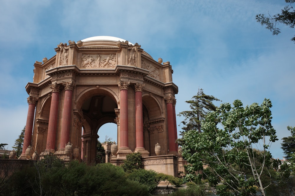 a large stone building with columns with Palace of Fine Arts in the background