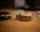 A close-up of a stylish men's bracelet on a wooden table.
