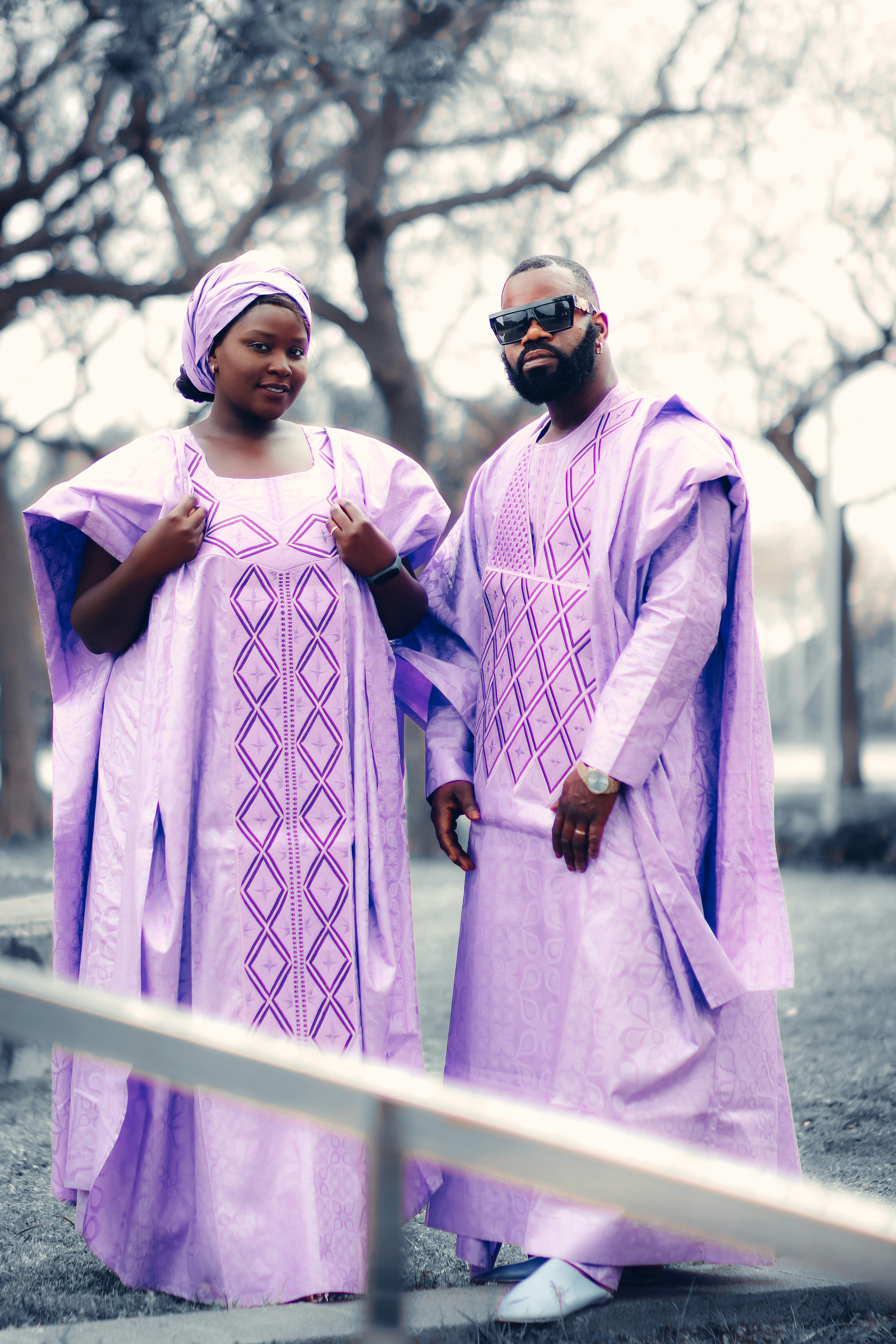 A man and woman wearing pink and white robes and standing outside photo ...