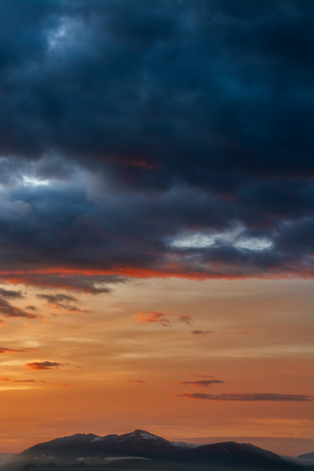 a colorful sky over mountains