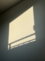 A clean, stylish frame of natural light casting soft shadows on a modern film set.