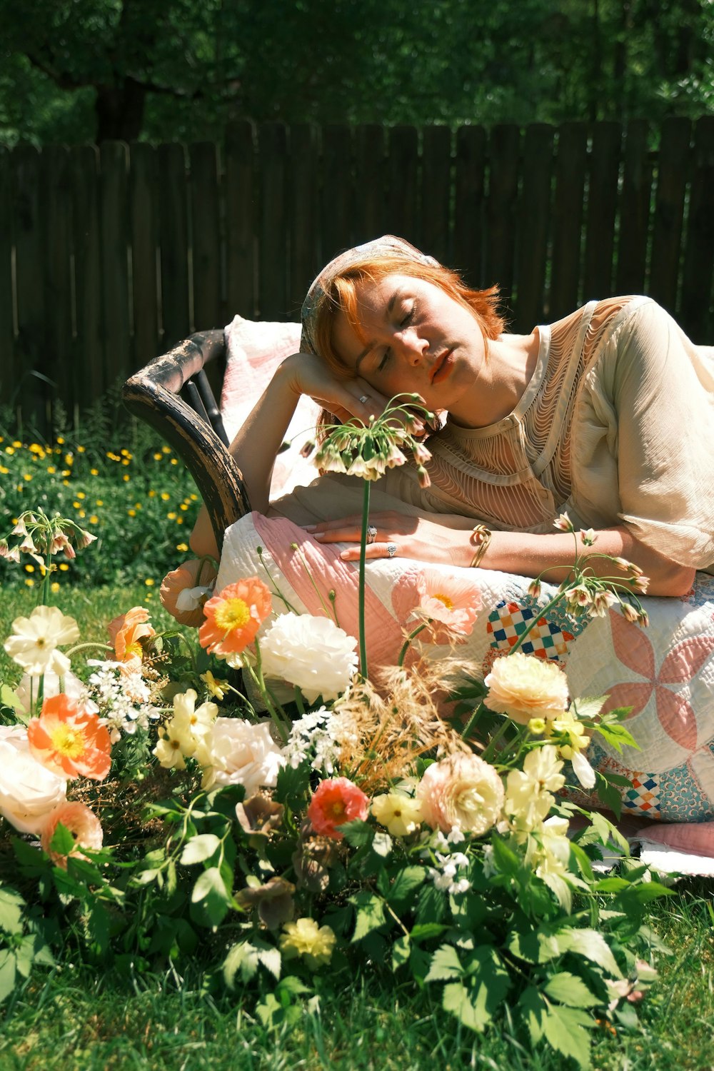 a person sitting in a chair surrounded by flowers