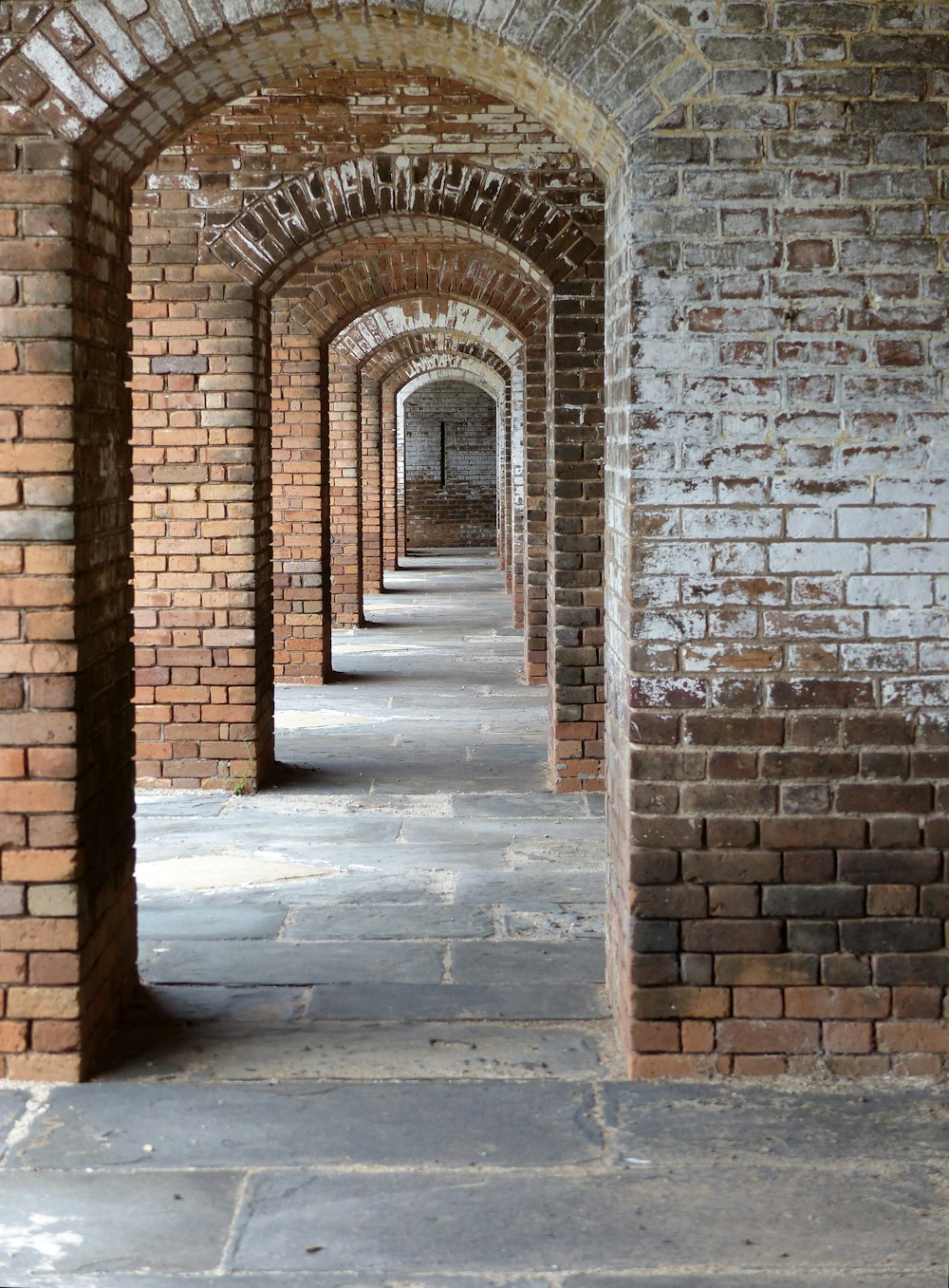 a brick wall with a door and a brick walkway