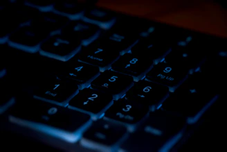 Close-up of hands swiftly pressing keys on a numeric keypad with a clean background.