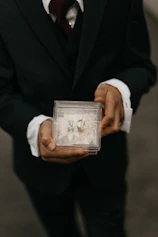 a man holding a picture of a man