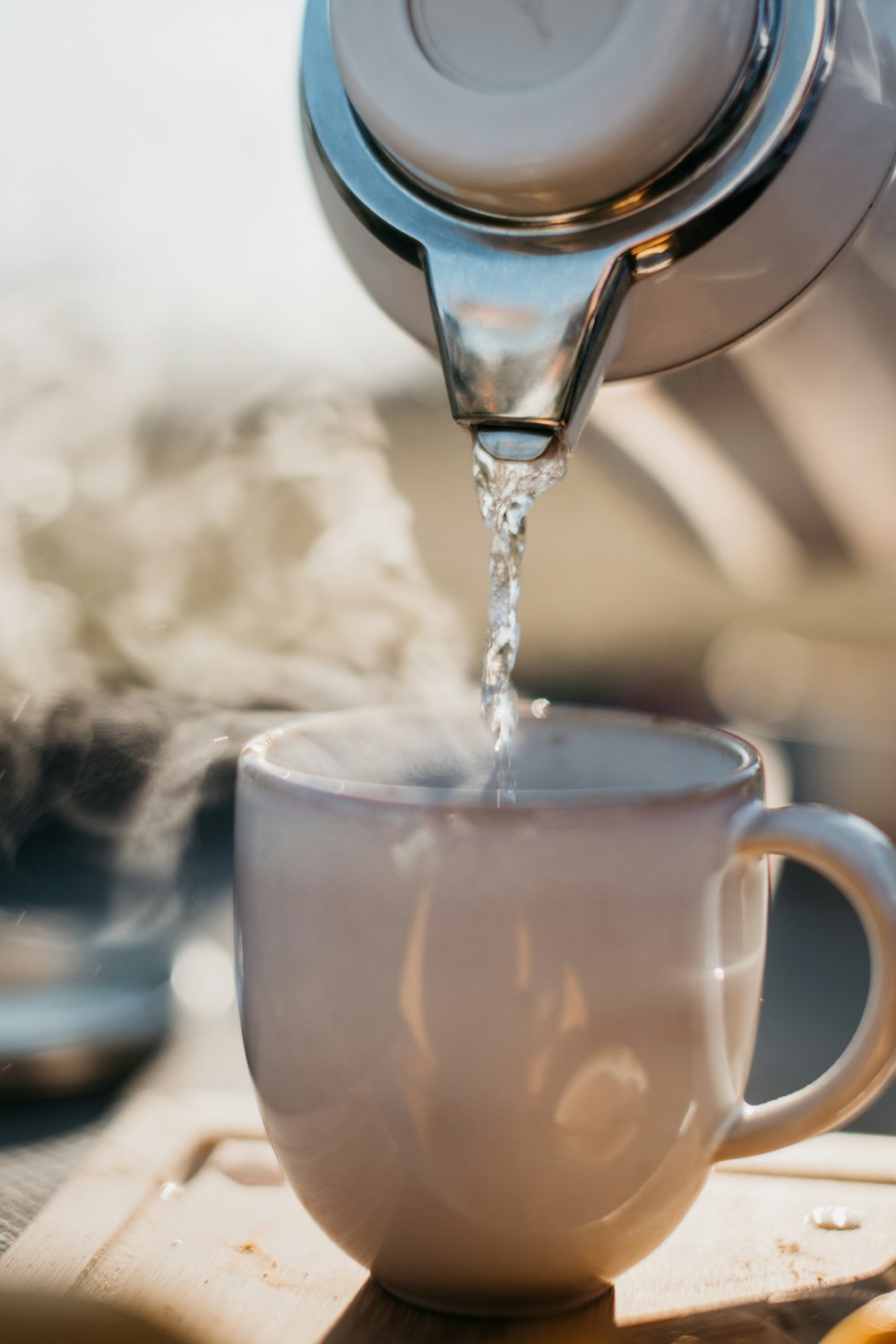 a glass pouring water into a cup