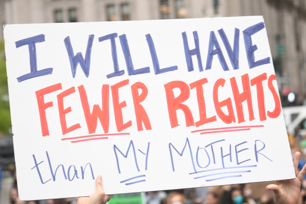 a group of people holding a sign