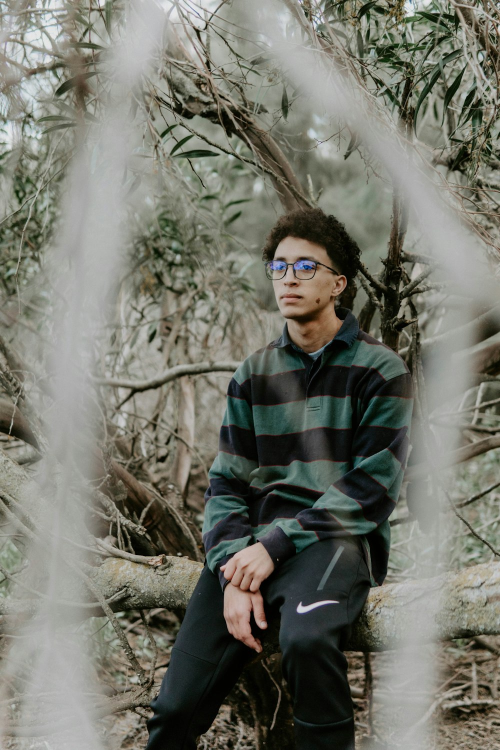 a man standing in front of a tree