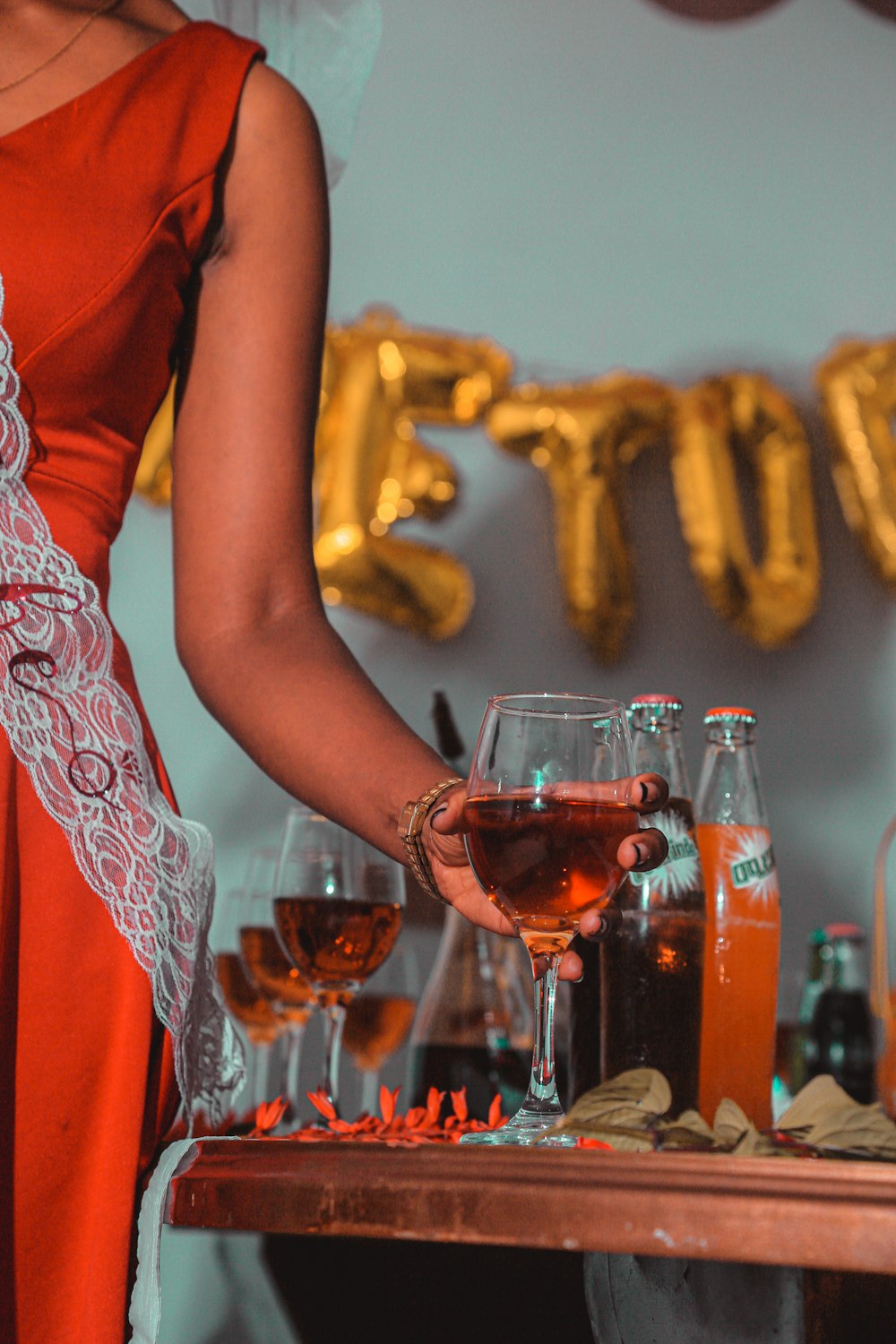 a person pouring a drink into glasses