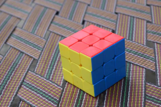A colorful assortment of Rubik's cubes arranged neatly on a wooden table, inviting curiosity.
