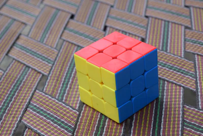 A colorful assortment of Rubik's cubes arranged neatly on a wooden table, inviting curiosity.