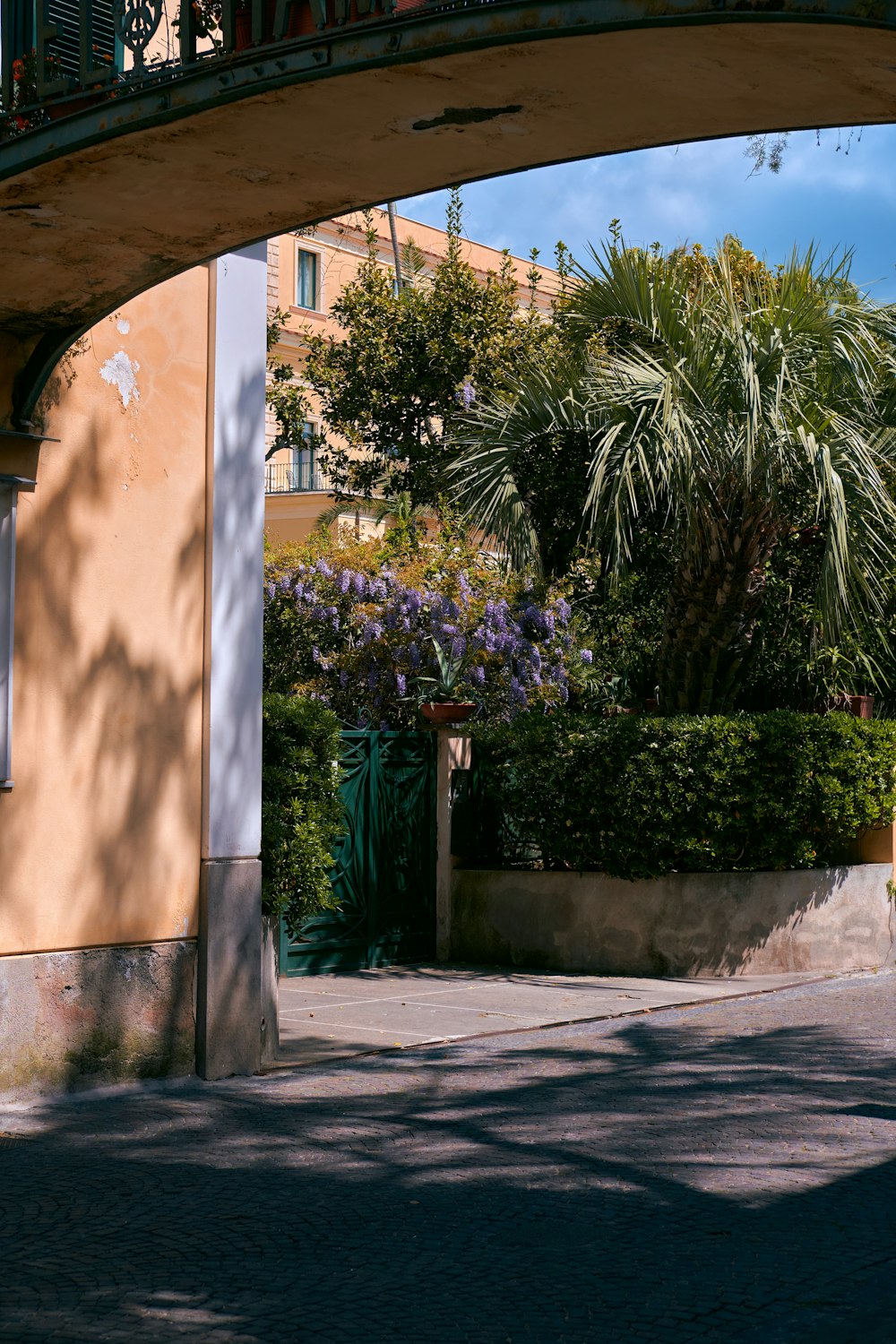 a building with a large archway and trees in the background