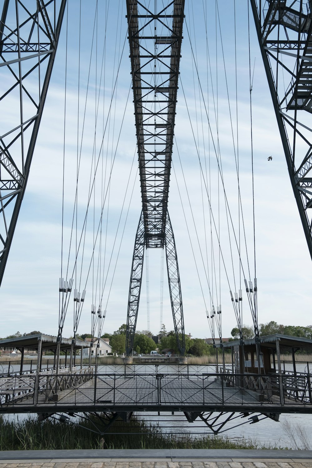 a bridge with cables and a metal tower