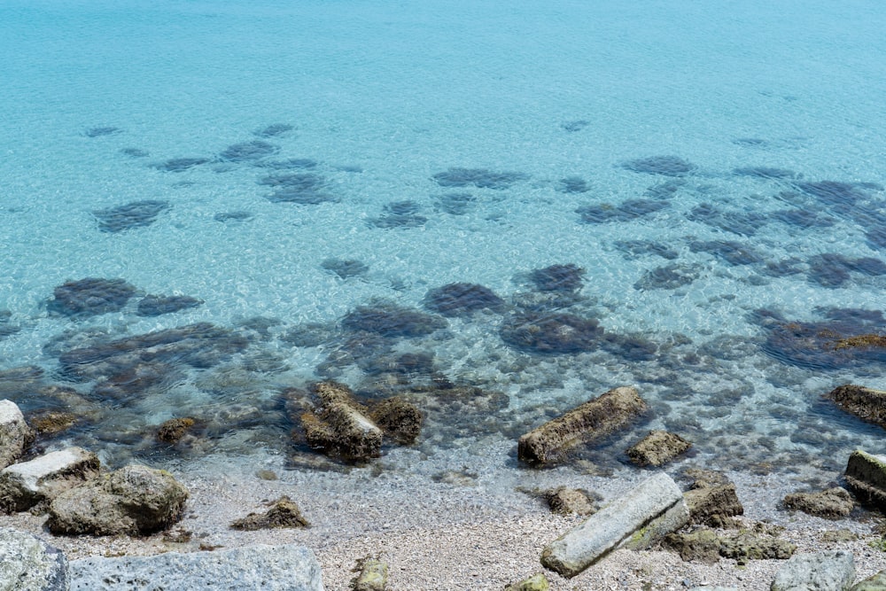 rocks and water with a beach