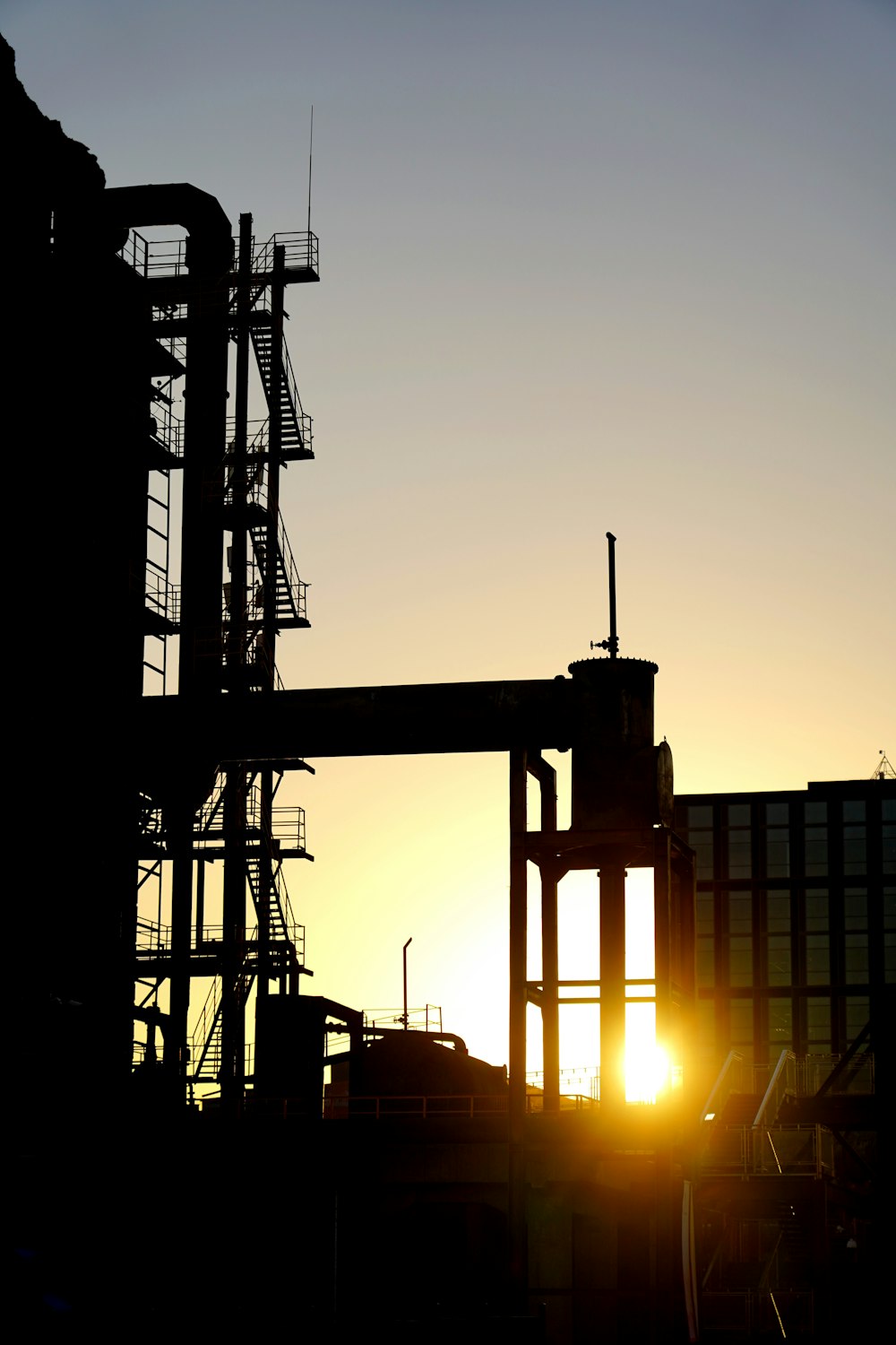 a large crane at sunset