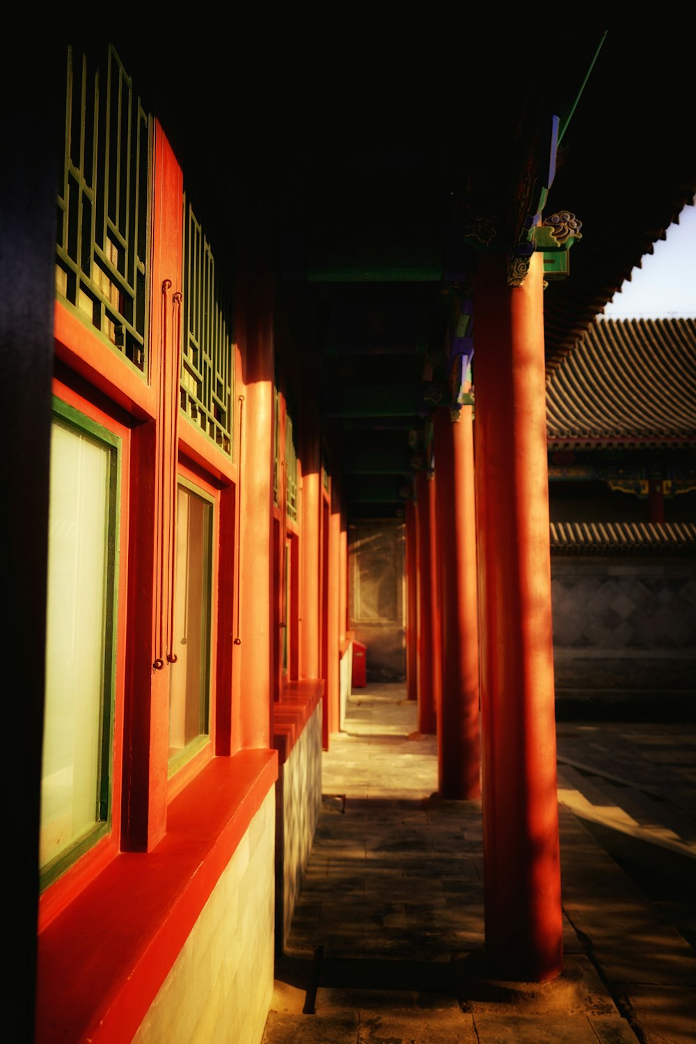 a train station with red pillars