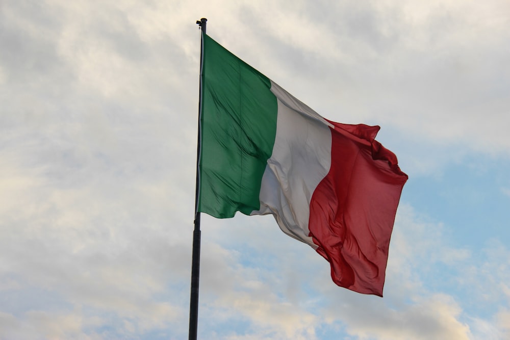 a couple of flags on a flagpole