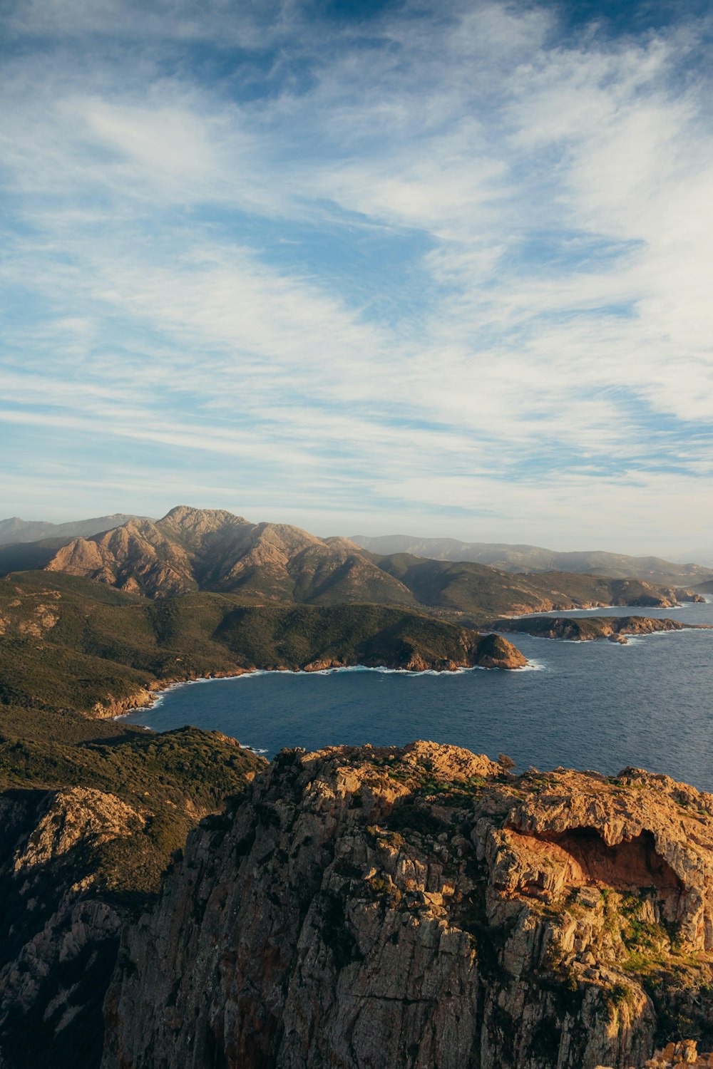 a body of water with mountains in the back