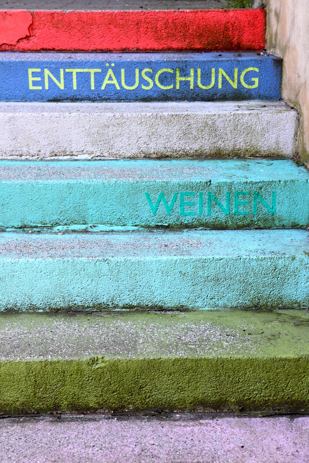 a set of stairs with green and red paint