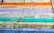 A series of colorful steps with motivational words in German. The steps are painted in various pastel shades including orange, yellow, lavender, turquoise, and green. Words like 'FRIEDEN', 'HOFFNUNG', 'VERTRAUEN', and 'VERSTÄNDNIS' are written on each step, adding an uplifting and positive theme.
