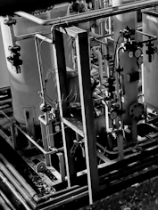 High-resolution photo of an industrial plant with technicians analyzing equipment.