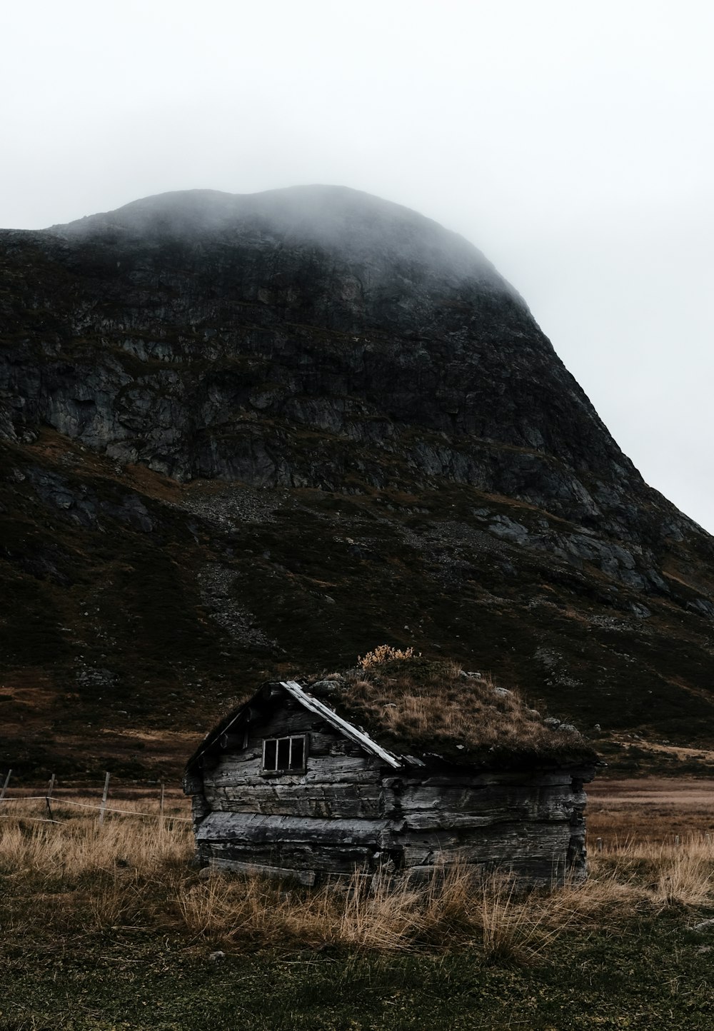 a house in front of a cliff