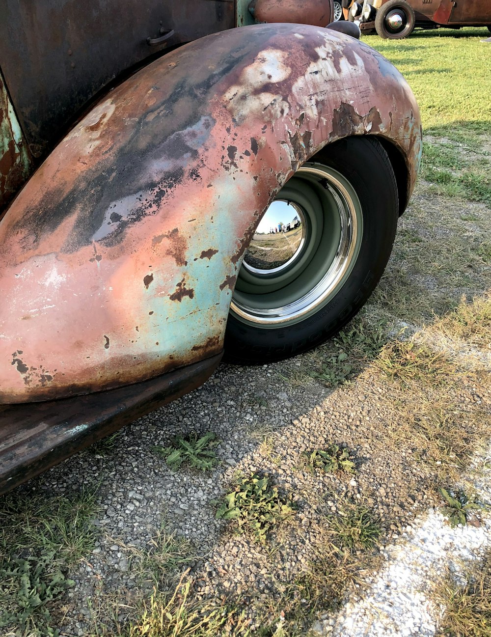 a car with a dent in the front wheel