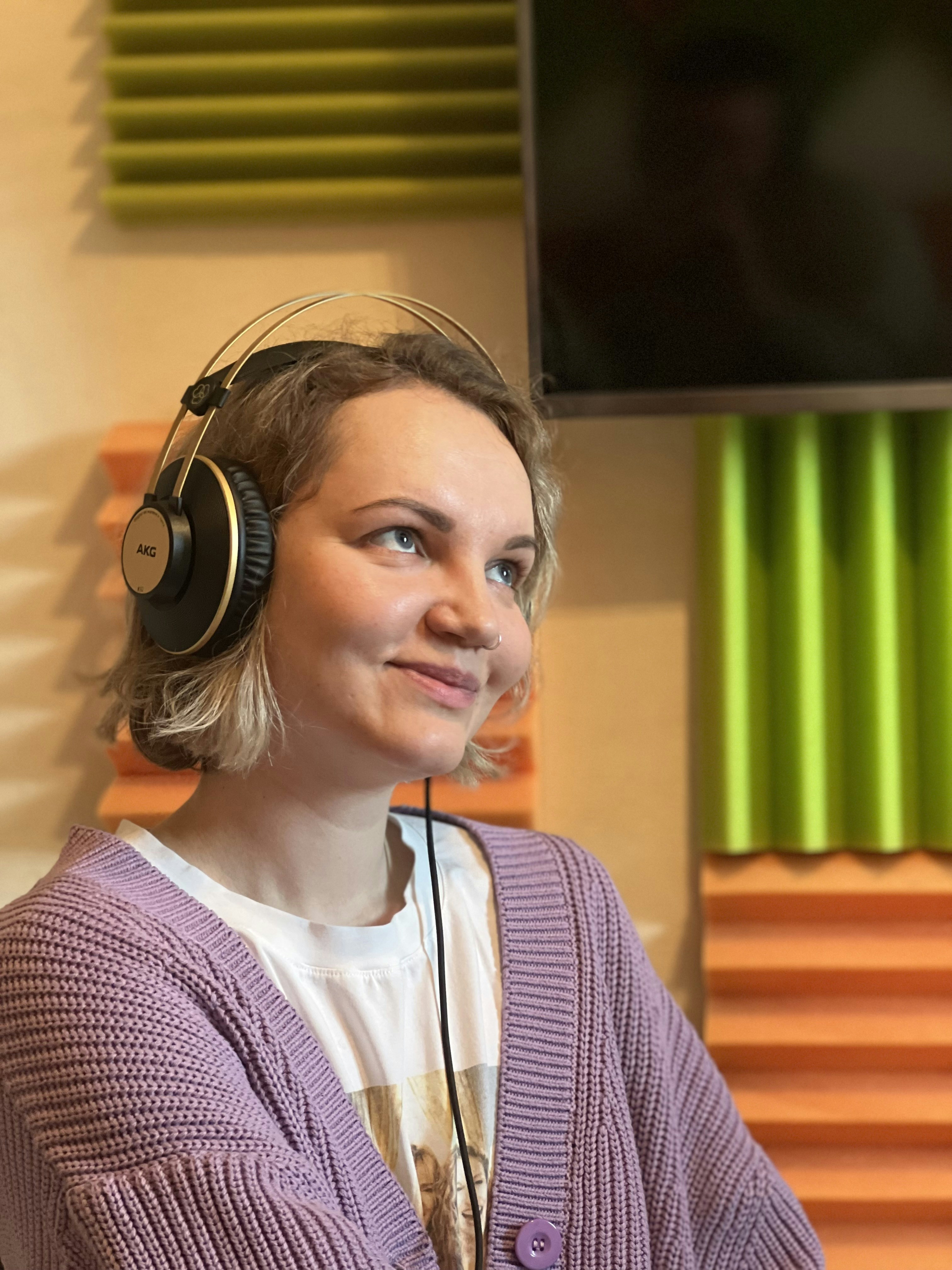 Portrait of Sarah Mitchell, woman wearing headphones in a studio