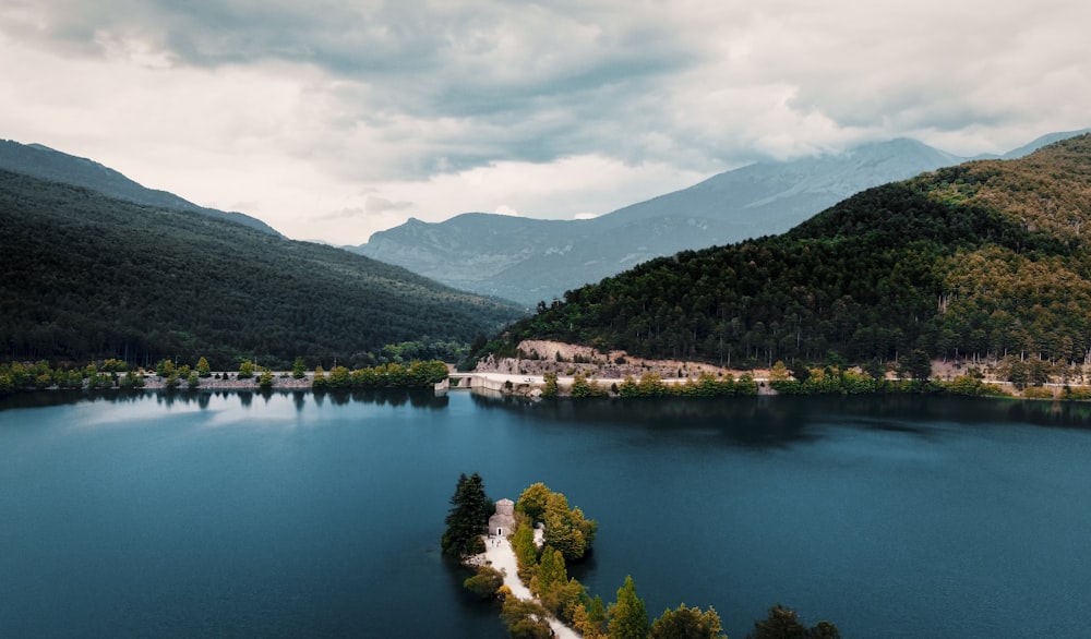 a body of water with trees and hills around it