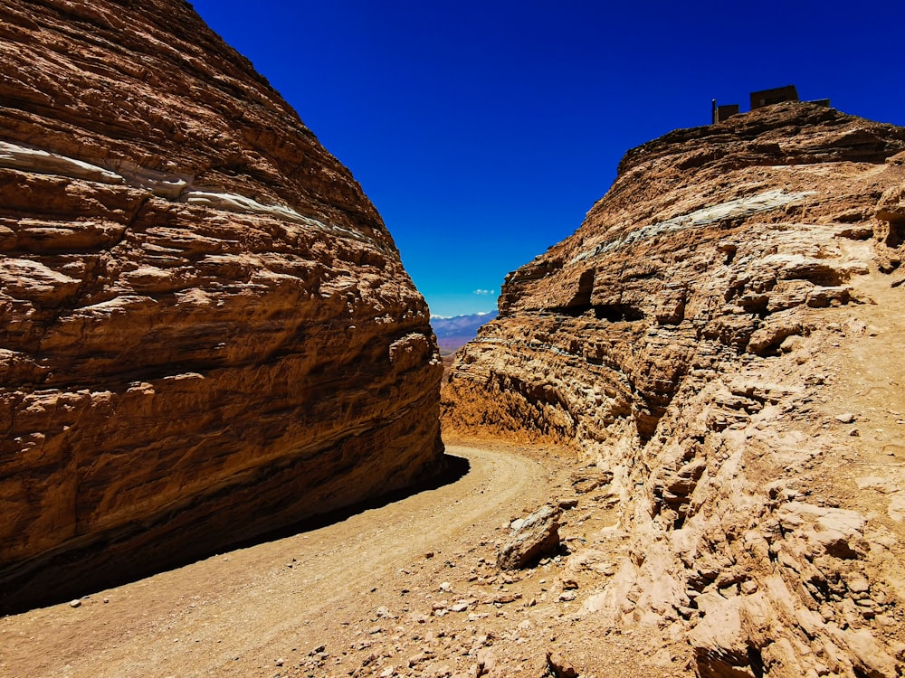 a rocky canyon with a blue sky