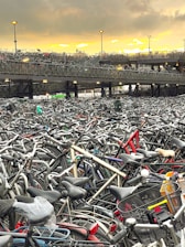 A well-organized bike parking area with multiple bicycles secured to racks under a bright blue sky.