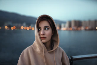 a woman with a scarf on her head looking at the camera