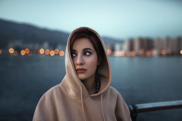 a woman with a scarf on her head looking at the camera