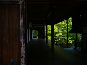 Interior of the garden villa featuring elegant wooden furniture and large windows with garden views.